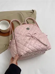 Chic pink quilted mini backpack with bow detail and metal buckle for women