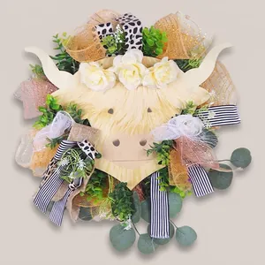 Highland cow floral wreath with white roses and plaid ribbons on a light blue door