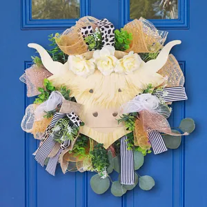 Highland cow floral wreath with roses and greenery on dark wood door for home decor