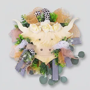 Highland cow floral wreath with roses and greenery on dark wood door for home decor