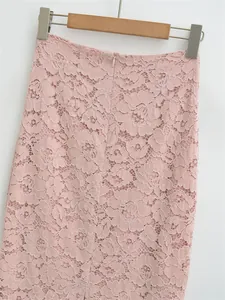 Close-up of pink lace skirt featuring floral embroidery and high-waist zipper closure