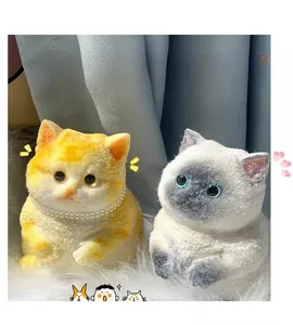 Detail of realistic plush cat squeeze toys with ginger and grey fur on white faux fur