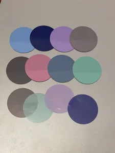 Close-up of 12 multi-color round waterproof indexing tabs on grey textured surface
