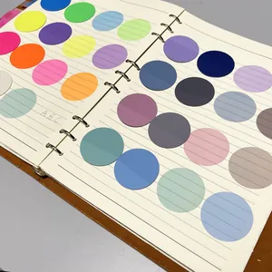 Detail of colorful transparent round index stickers on a white notebook page