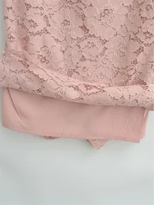Close-up of pink floral crochet lace fabric with a smooth matching inner lining