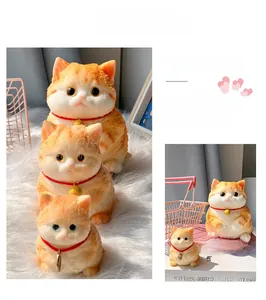 Squishy orange cat stress relief toy with velvet texture and golden bell collar detail