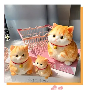 Three orange tabby cat squishy stress toys in various sizes with bell collars