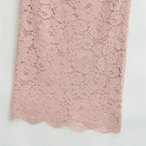 Pale pink high waist lace skirt featuring intricate floral patterns and scalloped hemline