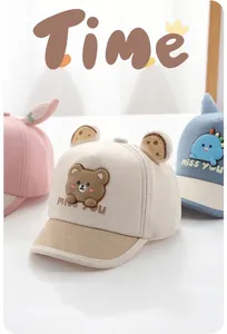 Detail of baby sun hats featuring beige bear, blue dinosaur and pink rabbit ears