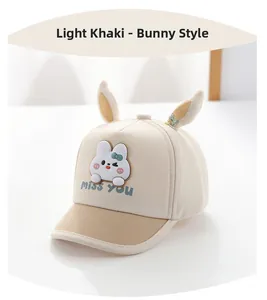 Close-up of light khaki baby sun hat with 3D rabbit ears and Miss You cartoon print