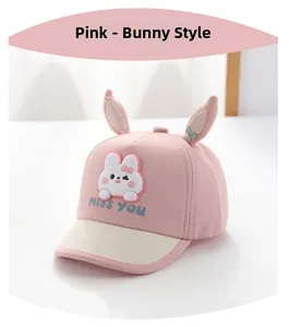 Detailed view of pink baby sun hat with cute rabbit ears and MISS YOU embroidery