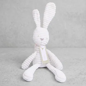 Detail shot of plush bunny face with embroidery and white corduroy texture