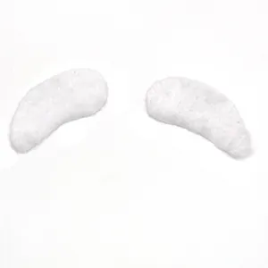 Close-up of fluffy white faux fur Santa eyebrows or mustache props for costumes