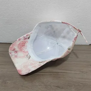 Detail view of pink floral print baseball cap interior lining and fabric texture