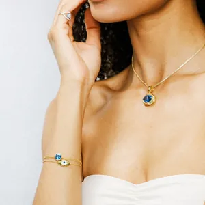 Close-up of elegant gold necklaces and evil eye jewelry set on female model