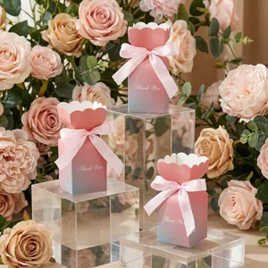 Detail of gradient favor box with pink ribbon bow and Thank You print on floral background
