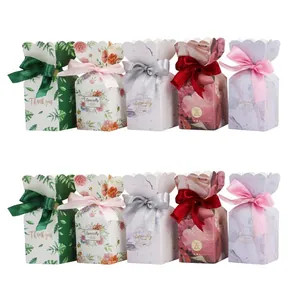 Five styles of colorful wedding candy boxes with floral patterns and silk ribbon bows