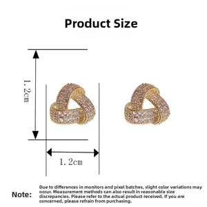 Detail showing 1.2cm x 1.2cm size of golden triangle studs with pavé cubic zirconia