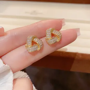 Elegant gold geometric triangle knot stud earrings with sparkling white zircons