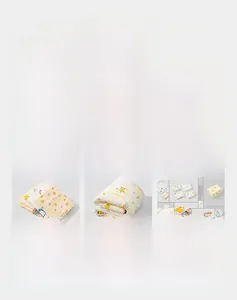 Detail shot of multi-layer cotton gauze baby swaddles and towels with cute animal prints