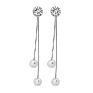 Detail of silver long tassel earrings with sparkling crystals and elegant white pearls