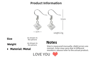 Detail shot of geometric cube drop earrings with cubic zirconia and size dimensions