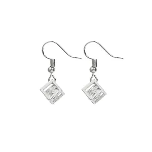 Macro view of silver geometric hollow cube earrings with sparkling square cubic zirconia