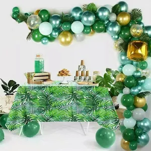 Detail of disposable PEVA tablecloth featuring vibrant green tropical palm leaf patterns