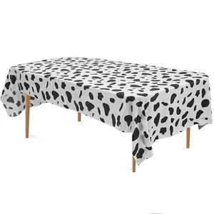 Rectangular disposable PEVA tablecloth featuring classic black and white cow print design