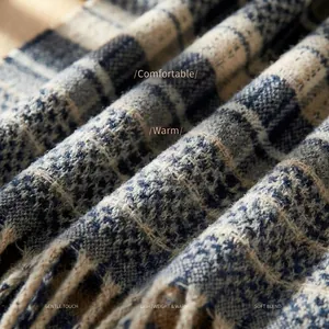 Blue and white plaid winter scarf made of soft blended fabric with fringe details