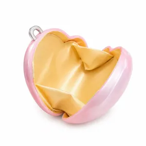 Pink heart-shaped acrylic evening clutch bag with gold satin lining and silver ring clasp