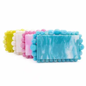 Acrylic evening clutch bags in marble pattern with beads in yellow, white, pink and blue