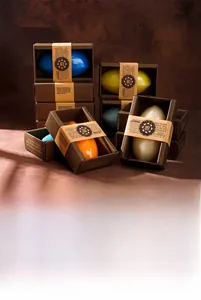 Detailed view of stacked assorted plant essential oil handmade soaps in elegant packaging