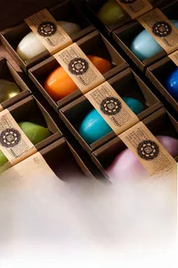 Detailed top view of assorted colorful essential oil soaps in kraft paper gift boxes