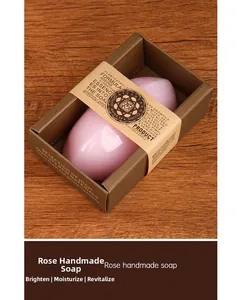 Detail of pink rose handmade soap in kraft box on a warm wooden texture background