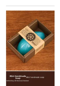 Macro shot of blue pebble-shaped peppermint handmade soap in premium gift packaging
