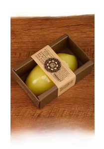 Detailed view of handmade lemon soap in a brown paper box with a kraft paper sleeve