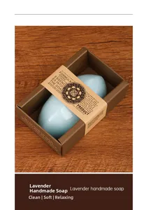 Detail of lavender handmade soap in a rustic brown gift box on wooden surface