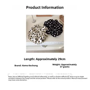 Detailed size view of oversized polka dot satin scrunchies measuring 29cm in length