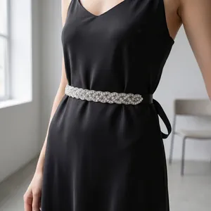 Detail showing hand-stitched silver rhinestone belt on a black deep V-neck evening dress