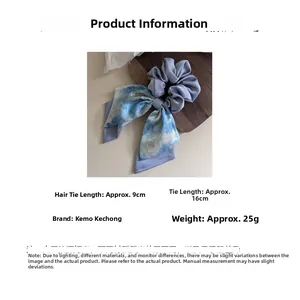 Detail of starry blue satin scrunchie with floral ribbon showing 9cm and 16cm dimensions