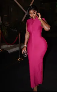 Detailed view of magenta sleeveless bandage dress with textured fabric and high neck