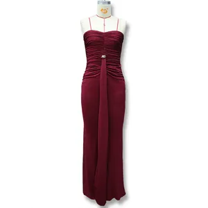 Detail of burgundy ruched maxi dress featuring a metal ring waist buckle and elegant draping