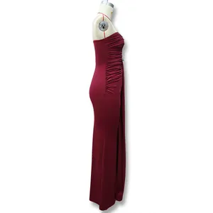 Detail view of burgundy strapless dress featuring side ruching and floor-length hemline