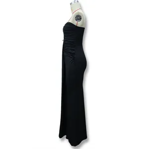 Detail view of the ruched side tailoring and high slit on this black strapless dress