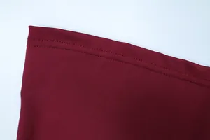 Detail shot of wine red fabric showing high-quality double stitching and fine texture