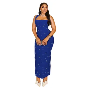 Detail of slim fit navy blue halter dress featuring vertical pearl patterns and rhinestones