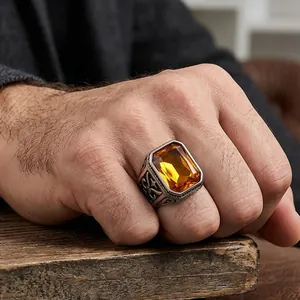 Men's vintage stainless steel ring with a large rectangular amber gemstone and carvings