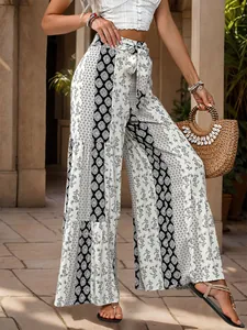 Detail of high waisted wide leg trousers featuring bohemian paisley and geometric patchwork