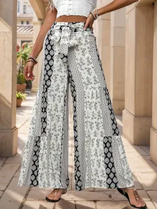 Detail of bohemian high waist wide leg pants with black and white geometric floral patterns